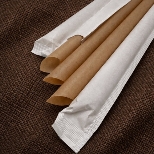 Close-up of 12mm slant-cut sugarcane boba straws, wrapped and unwrapped, on hessian